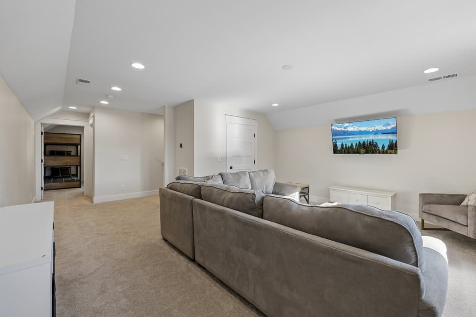 The Salem House loft with a spacious sitting area, sectional sofa, and bright neutral finishes.